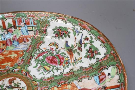 A 19th century Cantonese porcelain oval dish, decorated with panels of figures and birds, 42 x 34cm, height 4.5cm